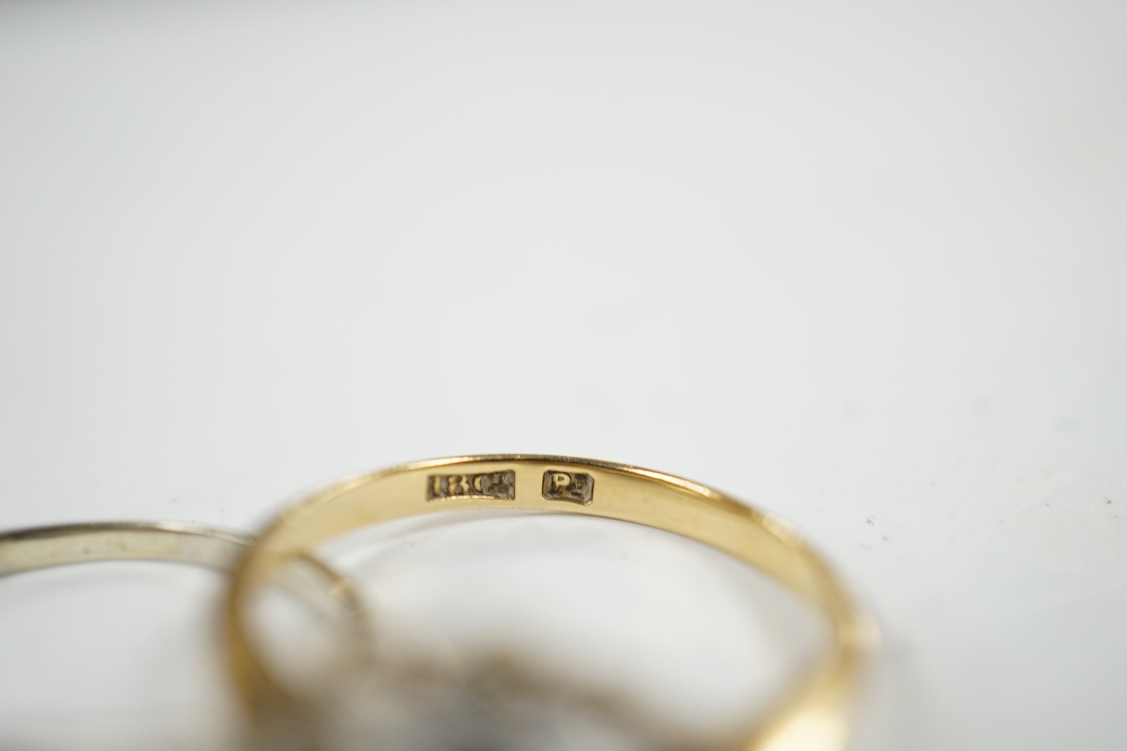 An early 20th century 18ct and plat, sapphire and diamond set cluster ring (stone missing), size N/O and a white metal, sapphire and diamond set two stone crossover ring, size M, gross weight 4.6 grams.